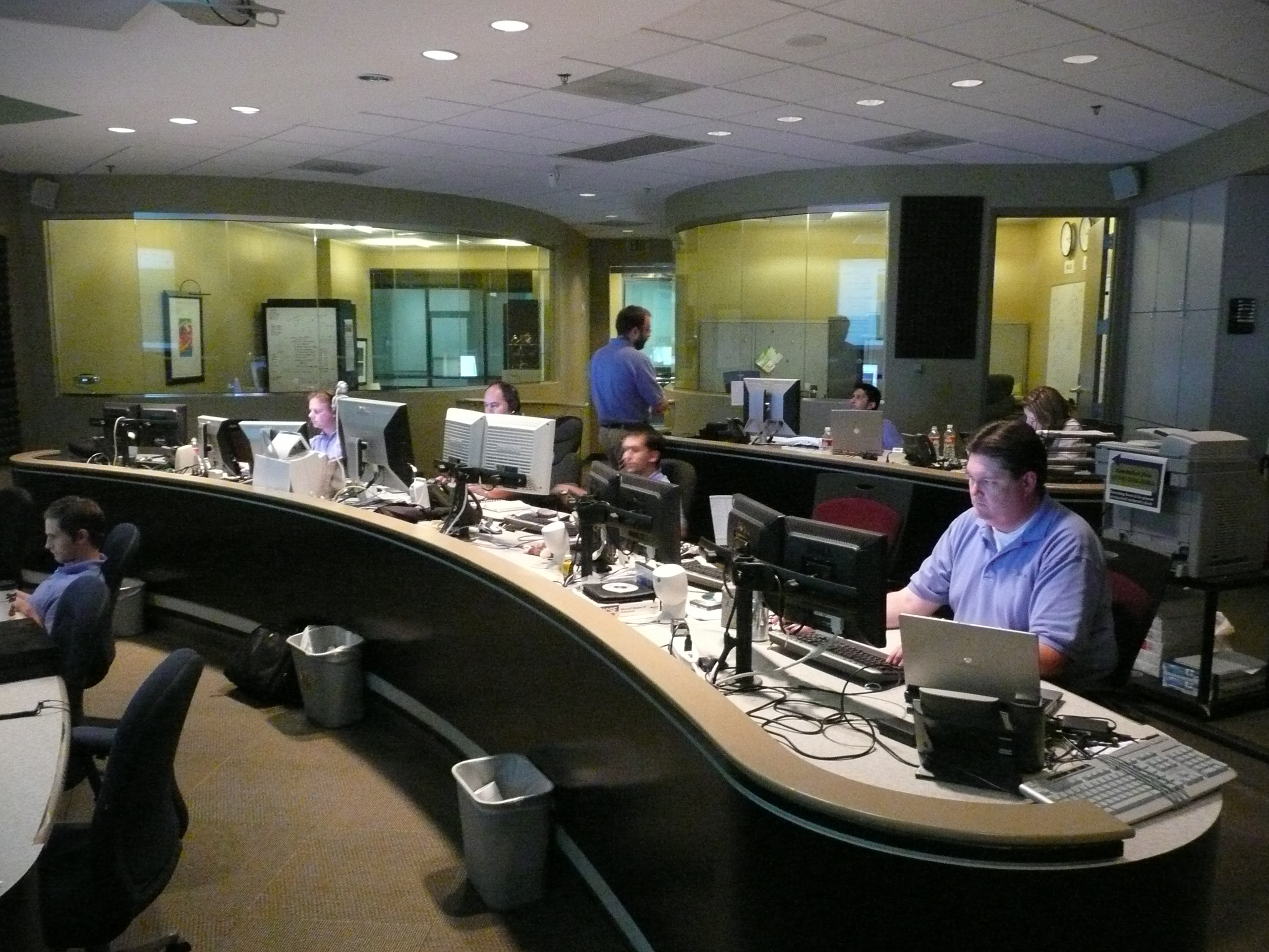 Network operations center with monitoring walls tracking infrastructure utilization